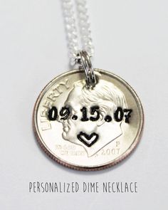 a personalized dime necklace with a heart on it