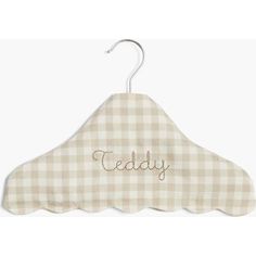 a wooden hanger with the word teddy on it