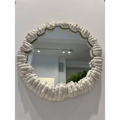 a white circular mirror mounted to the side of a wall