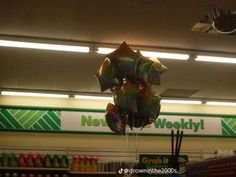 balloons are floating in the air at a grocery store's new year's eve celebration