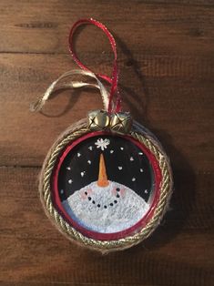 a christmas ornament hanging on a wooden table