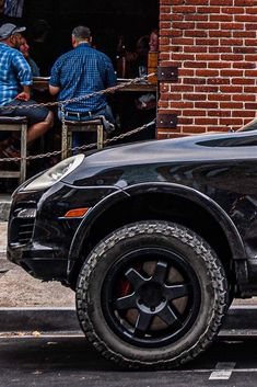 a black car parked on the side of the road