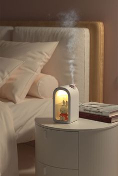 an alarm clock sitting on top of a night stand in front of a white bed