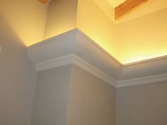 the corner of a room with a light fixture on it's ceiling and an open window