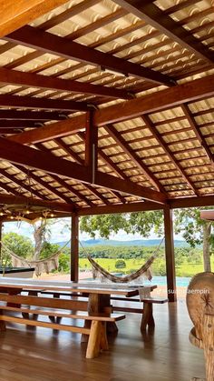 an outdoor area with benches and hammocks