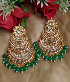 Shine like a glowing star in this high quality gold toned Kundan earrings lined with fine lustrous pearls.Pair them up with your silks and satins add charm and charisma to your beautiful personality Earrings length 4 inches Width 2.3 inches Weight 84 gm Keep your precious Kundan jewelry away from perfume,spray and water.Keep it away from direct heat, water, perfumes, deodorants and other strong chemicals as they may react with the metal or plating.The plating composition of Jewellery is as such Elegant Bridal Earrings With Zari Work For Diwali, Elegant Bridal Earrings With Zari Work For Festivals, Festive Elegant Bridal Earrings With Gota Work, Gold Earrings With Zari Work For Eid, Bollywood Style Gold Earrings With Zari Work, Temple Jewelry Style Bridal Earrings With Zari Work, Elegant Green Jhumkas With Zari Work, Festive Bollywood Pearl Earrings For Celebration, Green Zari Work Earrings For Wedding