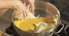 someone is cooking pasta in a pot on the stove