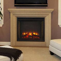 a living room with a fire place and couches in front of the tv on the wall