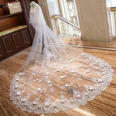 a wedding veil with flowers on the floor