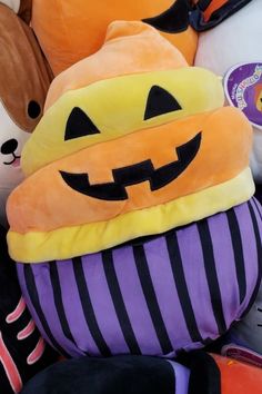 a pile of stuffed animals with pumpkins on them