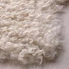 the wool is white and fluffy on the floor