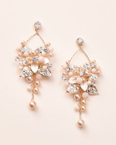 Feminine & floral, our Penelope Pearl Dangle Earrings are crafted with metal flowers, jeweled leaves, crystals, pearls & beads in a front facing hoop design. Lightweight for easy all day wear. Jeweled metal flowers, crystals, pearls & beads Silver is made with off white pearls & beads & the gold is made with champagne pearls & blush beads Measures 1.25" x 3" Hypoallergenic, lead-free & nickel-free Style #4425 Vine Headband, Pearl Dangle Earrings, Headband Tiara, Hoop Design, Free Style, Pearl Earrings Dangle, Metal Flowers, Gold Earrings Dangle, Bridesmaid Earrings