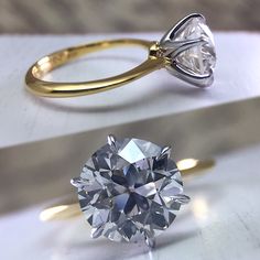 a close up of a ring with a diamond on the side and a single stone in the middle