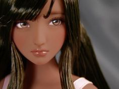 a close up of a doll with long hair