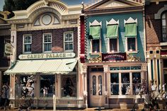 an old fashioned store front with people walking by