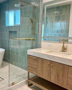 a bath room with a tub a sink and a shower head mounted to the wall