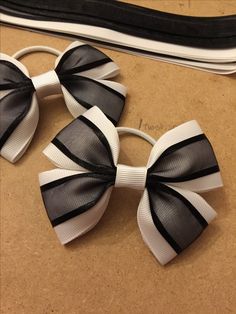 three black and white hair bows sitting on top of a table