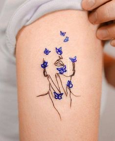 a woman's thigh with blue butterflies on it