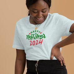 "Introducing our vibrant and celebratory \"Happy New Year 2024 Shirt\" - the perfect attire to ring in the festivities with style and joy! Crafted with comfort and a dash of flair, this Happy New Year T-shirt is designed to make a statement at every New Year's gathering. This t-shirt is everything you've dreamed of and more. It feels soft and lightweight, with the right amount of stretch. It's comfortable and flattering for all.  * 100% combed and ring-spun cotton (Heather colors contain polyester) * Fabric weight: 4.2 oz./yd.² (142 g/m²) * Pre-shrunk fabric * Side-seamed construction * Shoulder-to-shoulder taping * Blank product sourced from Nicaragua, Mexico, Honduras, or the US This product is made especially for you as soon as you place an order, which is why it takes us a bit longer t New Year Gift Crew Neck T-shirt, Happy New Year 2024, New Year Party, Long T, Year 2024, New Years Party, Nouvel An, Party Shirts, New Year's