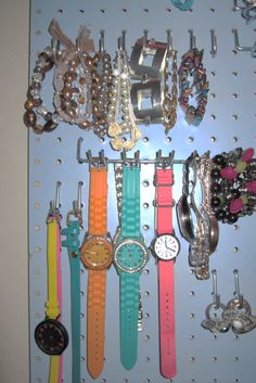 there are many watches and bracelets hanging on the wall