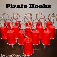 there are many red buckets that have silver handles on them, and the words pirate hooks above them