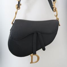 Authentic Classic Black Dior Saddle Bag. Authenticity Card Included. Absolutely No Wear And Tear. Bag Is In New Condition. Has Never Been Worn, Has Never Held Any Contents. Luxury Black Saddle Bag With Detachable Strap, Black Luxury Saddle Bag With Detachable Strap, Luxury Black Saddle Bag With Detachable Handle, Luxury Black Saddle Bag For Evening, Designer Saddle Bag With Branded Hardware For Formal Events, Elegant Black Saddle Bag With Dust Bag, Evening Black Saddle Bag With Palladium Hardware, Luxury Saddle Bag With Gold-tone Hardware, Luxury Saddle Bag With Detachable Strap