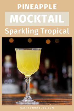 pineapple mocko cocktail in a coupe glass with text overlay reading pineapple mocko cocktail sparkling tropical