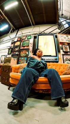 a man sitting on top of a yellow couch