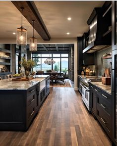 a large kitchen with wooden floors and black cabinets