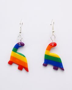 the earrings are made out of plastic and have a rainbow colored horse on it's side