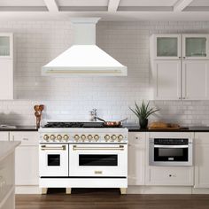 a white stove top oven sitting inside of a kitchen