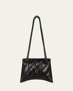 Balenciaga "Crush" shoulder bag in pad quilted calf leather     Tonal sliding chain shoulder strap can be doubled, 19.6" drop    Flap top with magnetic closure; hanging B logo medallion     Exterior, one slip pocket under flap     Interior, one zip pocket     Approx. 5.1"H x 7.4"W x 3.1"D    Made in Italy B Logo, Quilted Shoulder Bag, Small Quilts, Chain Shoulder Bag, Magnetic Closure, Calf Leather, Balenciaga, Zip Pockets, Tops Designs