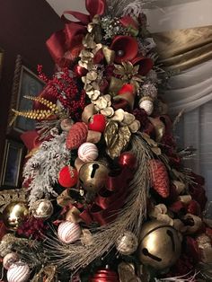 a christmas tree decorated with red and gold ornaments