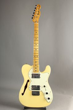 an electric guitar sitting on top of a stand