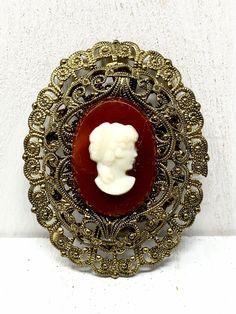 West Germany Filigree Two Tone White Cameo Brooch  This lovely piece can be worn on any occasion and is absolutely beautiful in the light, both inside and out, the perfect gift for anyone who loves vintage jewelry.  Colors and Shades may vary due to Lighting                            "Questions" Please read description carefully before buying to avoid confusion and cancellations. Please ask questions accordingly if needed. I do my best to answer emails promptly. - Measures Approx.  2" long - Each order comes shipped in a small drawstring pouch, all ready for     gifting. -If you are wanting to have this mailed as a gift to a special someone,  please write their address in the note section, otherwise it will be mailed to you. -If you would like to add a special typed note added to the orde Victorian Baroque Brooches As Gifts, Heirloom Cameo Brooch Gift, Heirloom Cameo Brooches As Gift, Heirloom Cameo Brooches For Gifts, Victorian Filigree Brooches For Vintage Events, Antique Cameo Brooches As Gift, Vintage Baroque Brooch Jewelry, Antique Cameo Brooches For Gift, Antique Brooches With Vintage Charm As Gift