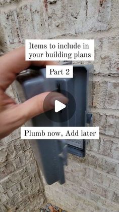 a hand is pointing to a building plan on a brick wall with the words, items to include in your building plans part 2 plumb now add later