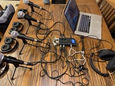 there are many microphones and headphones on the table