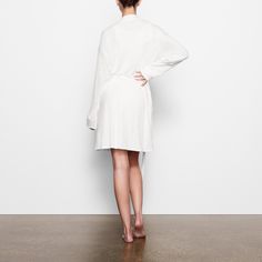 Perfect for lounging and layering over sleepwear, the Soft Lounge Robe is composed of super-soft modal ribbed fabric that drapes effortlessly in all the right places. This short robe features an adjustable self-tie belt and functional side pocket at inseam. | SKIMS Robe | White | Soft Lounge V-neck Robe With Tie Waist For Loungewear, Long Sleeve Cotton Robe For Loungewear, Modal Sleepwear For Sleep, Solid Modal Sleepwear, Spring Lounging Sleepwear In Modal, White Tie Waist Long Sleeve Robe, Relaxed Fit Long Sleeve Lounging Robe, Wrap Sleep Robe With Tie Waist, Wrap Robe With Tie Waist For Sleep