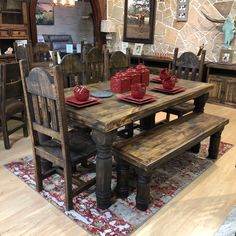 a rustic dining table with matching chairs and benches