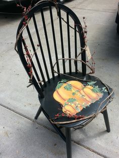 a black chair painted with oranges on it