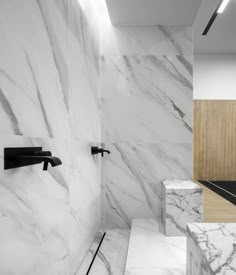 a bathroom with white marble walls and flooring