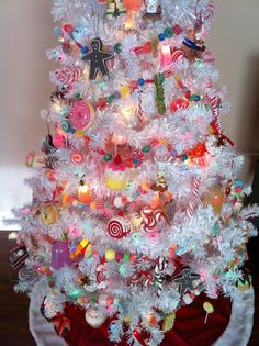 a white christmas tree decorated with candy canes and candies