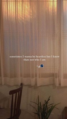 there is a window with sheer curtains and a chair in front of the window that says, sometimes i wannan be heartless but i know thats not who i am