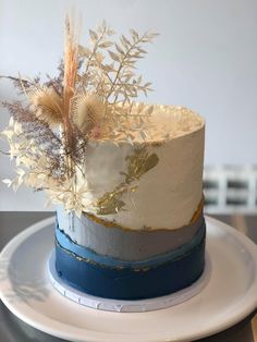 a white and blue cake sitting on top of a plate