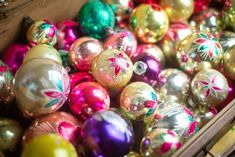 a box filled with lots of different colored ornaments