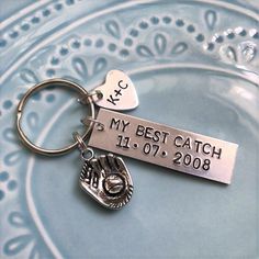 a metal keychain with a hand stamped tag on it