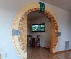 a living room filled with furniture and a flat screen tv mounted to the side of a wall