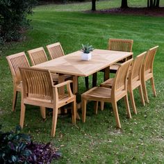 a wooden table and chairs in the grass