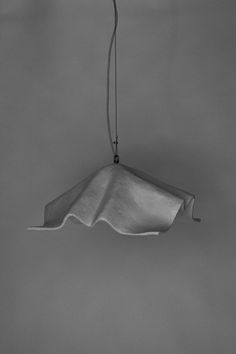 a black and white photo of a light fixture hanging from the ceiling in a room