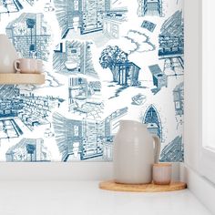 a blue and white wallpaper with houses on it